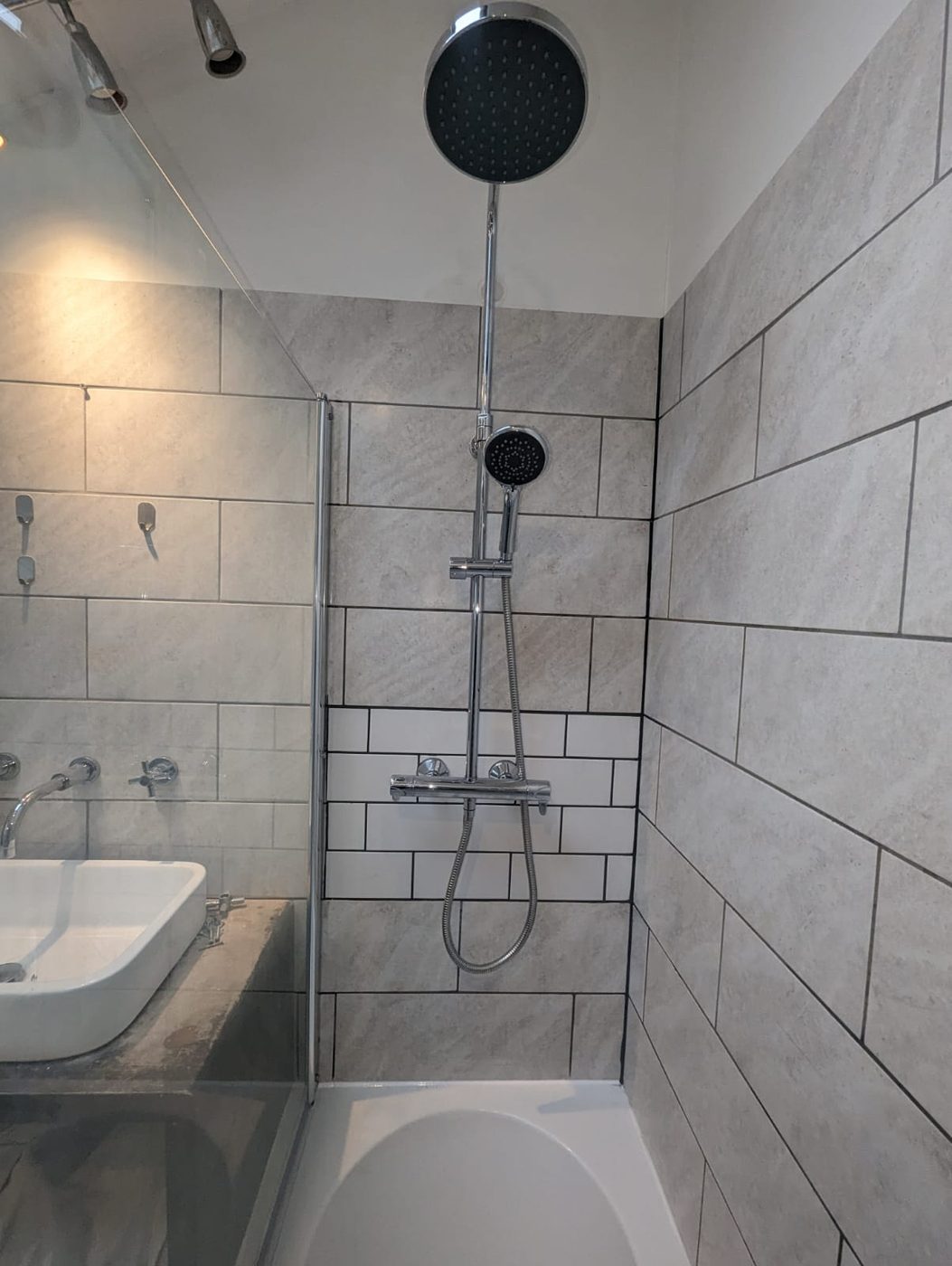 Finished tiled bathroom with shower over bath