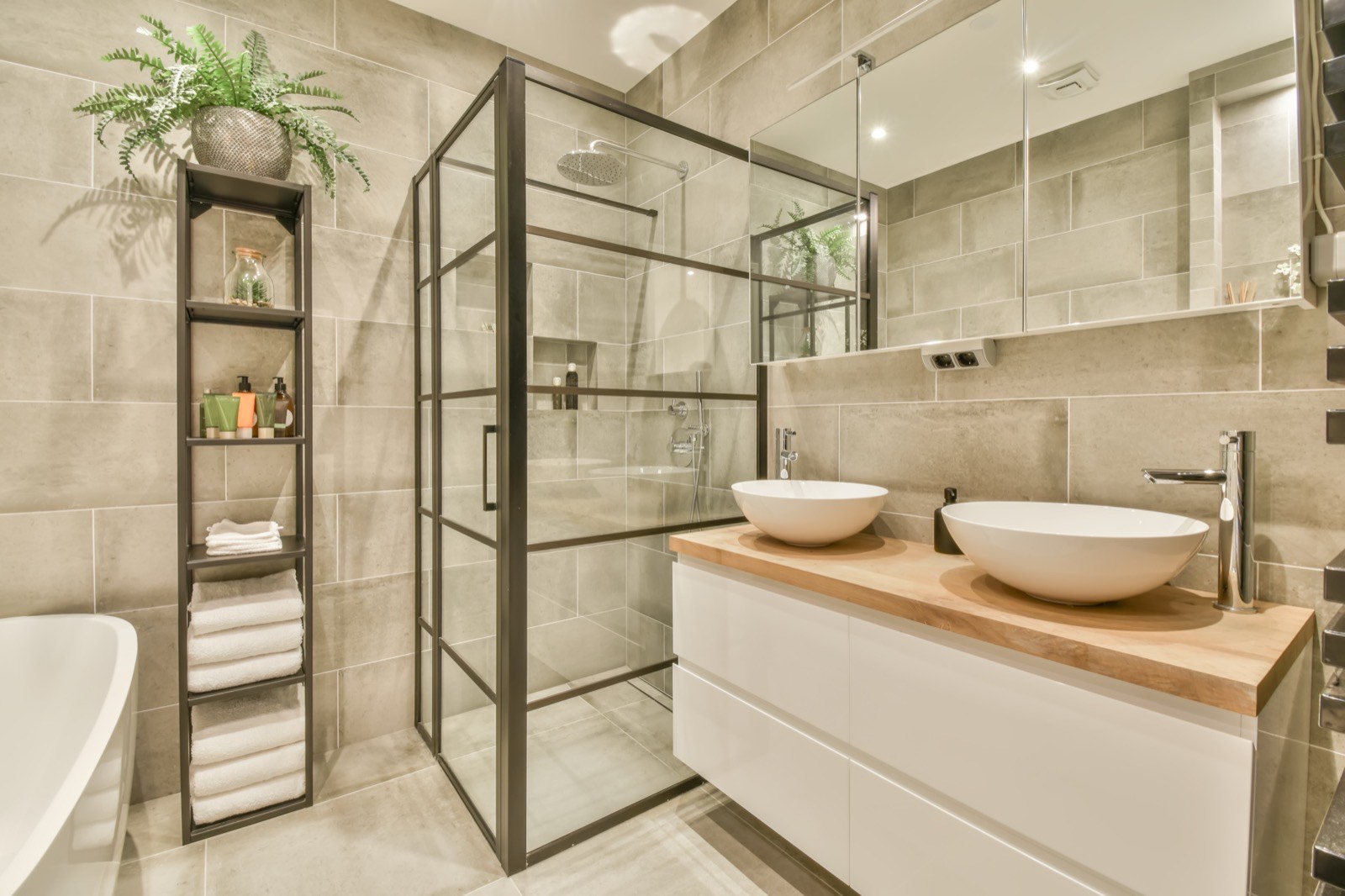 Completed bathroom with walk-in shower, basin and heated towel rail