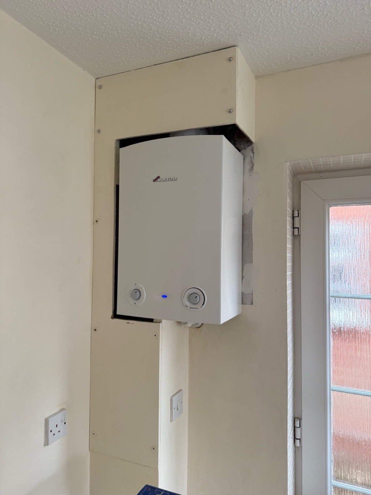 Combi boiler neatly fitted in a utility room by Plumbing Angels
