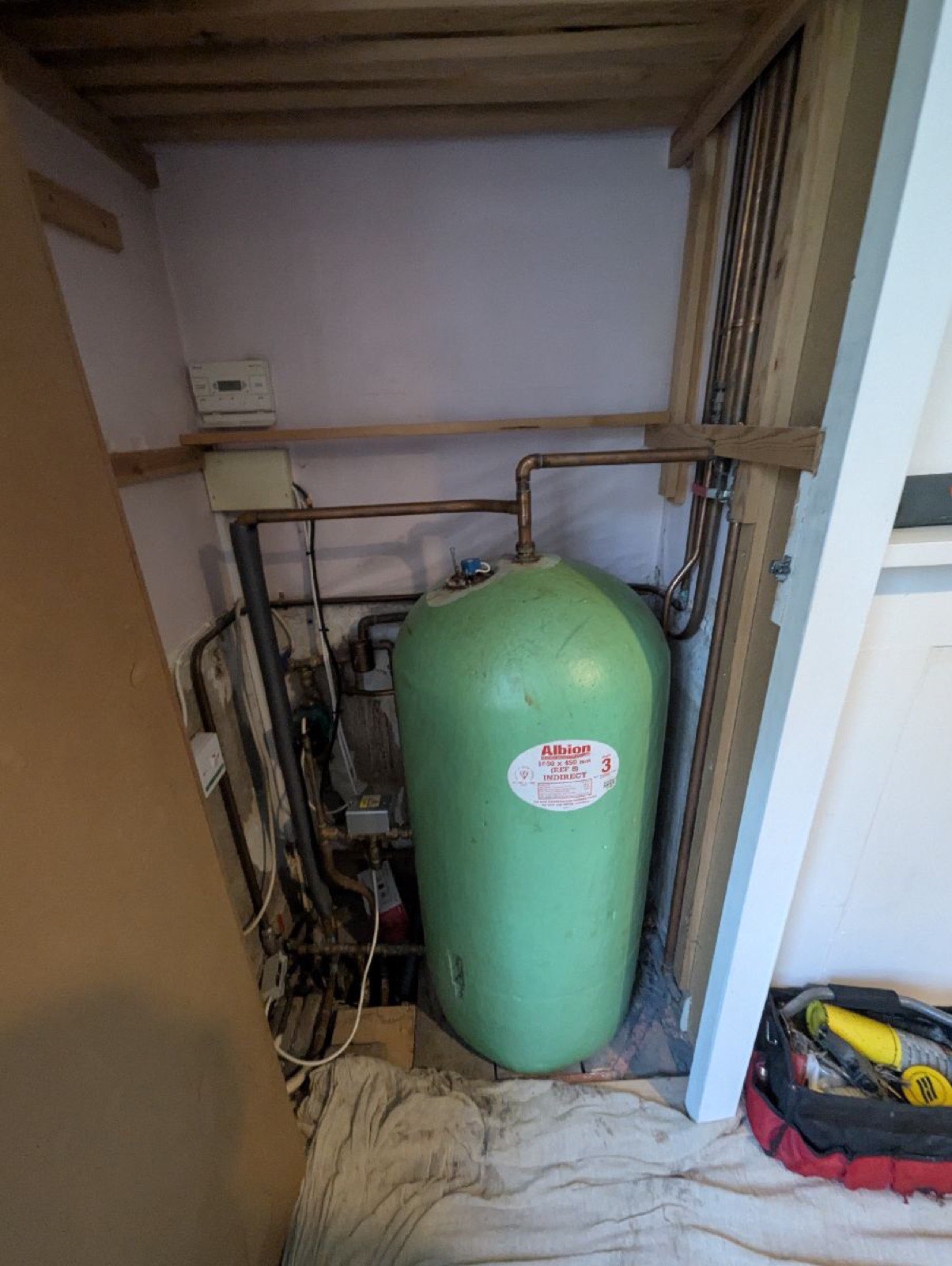 Hot water cylinder fitted in an airing cupboard