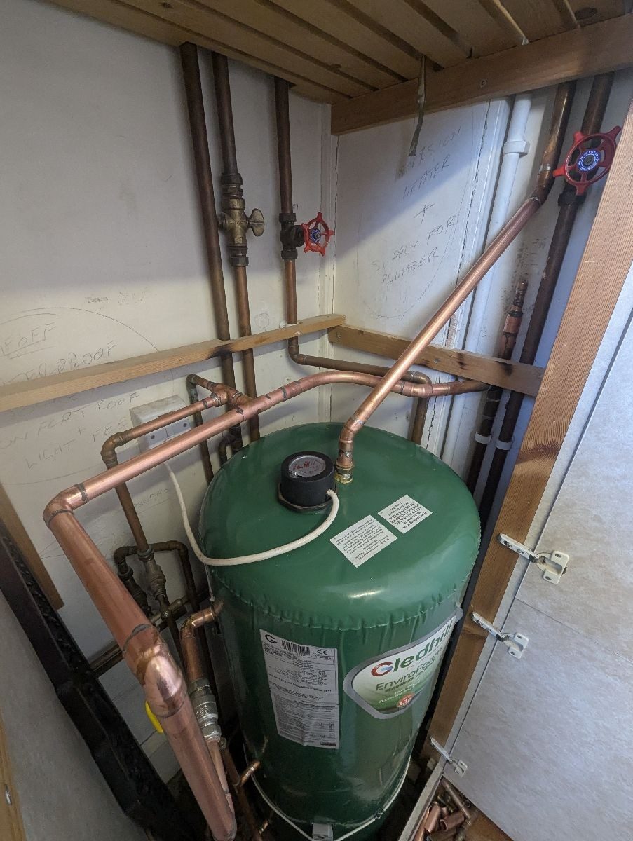 Hot water cylinder with neat copper pipework