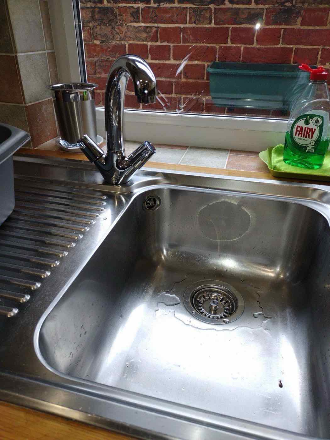 Kitchen sink with black mixer tap fitted by our plumbers