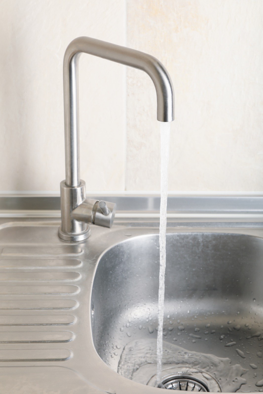 Stainless steel kitchen sink and mixer tap after fitting