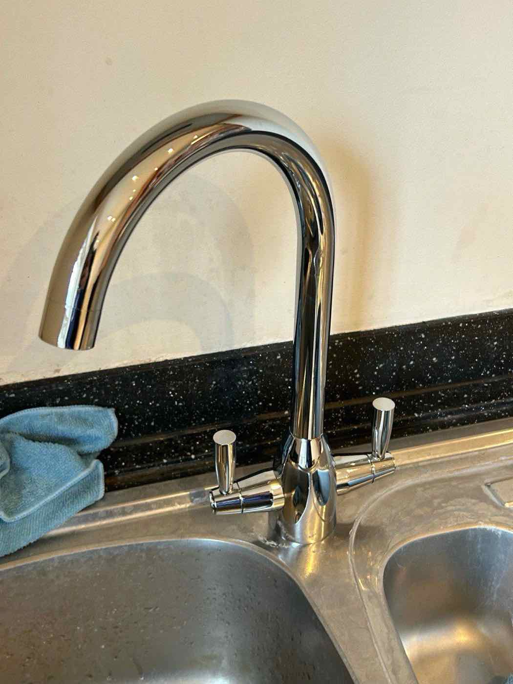 Brass swan-neck kitchen tap installed by Plumbing Angels