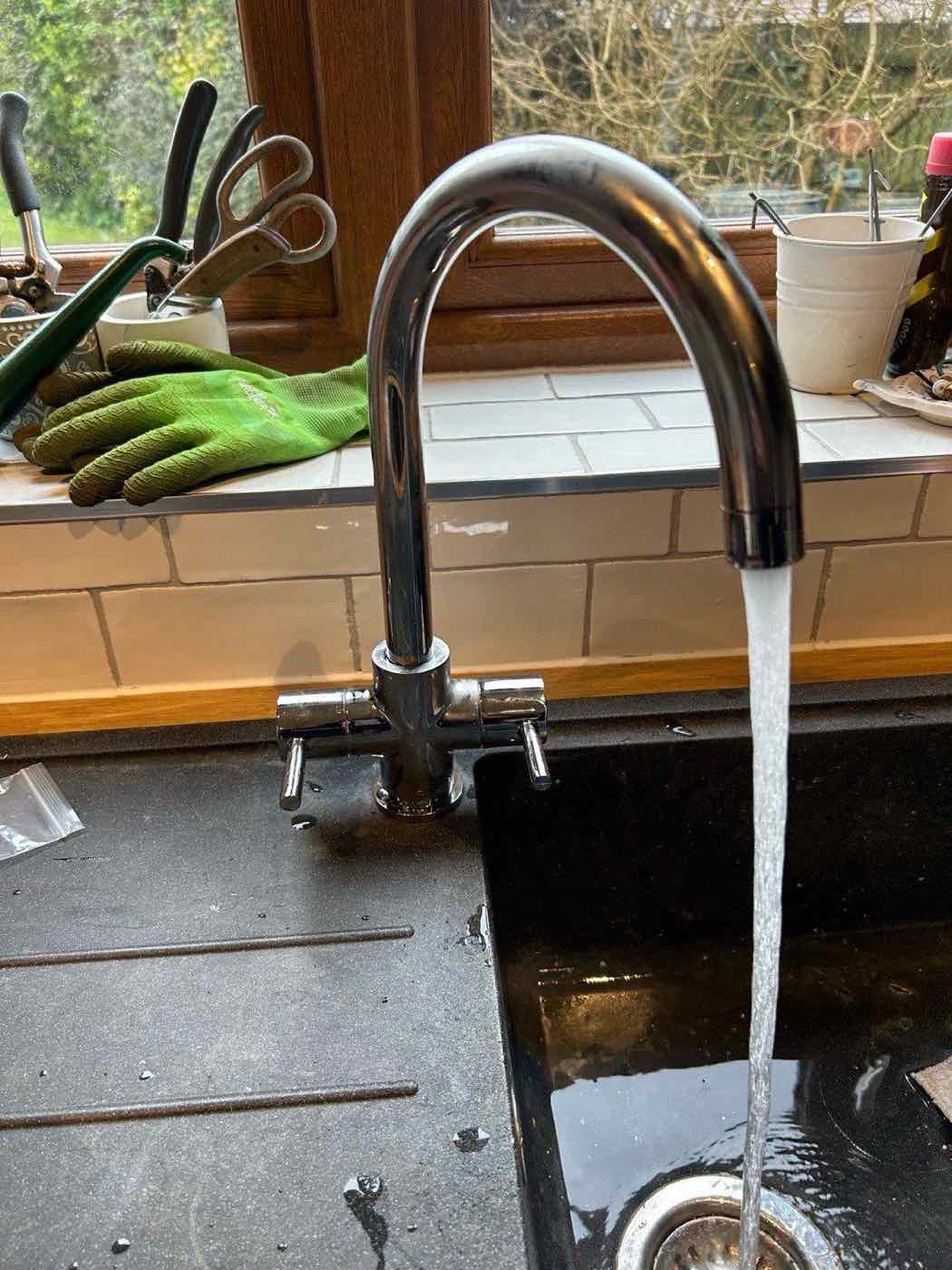 Newly fitted kitchen mixer tap running after installation