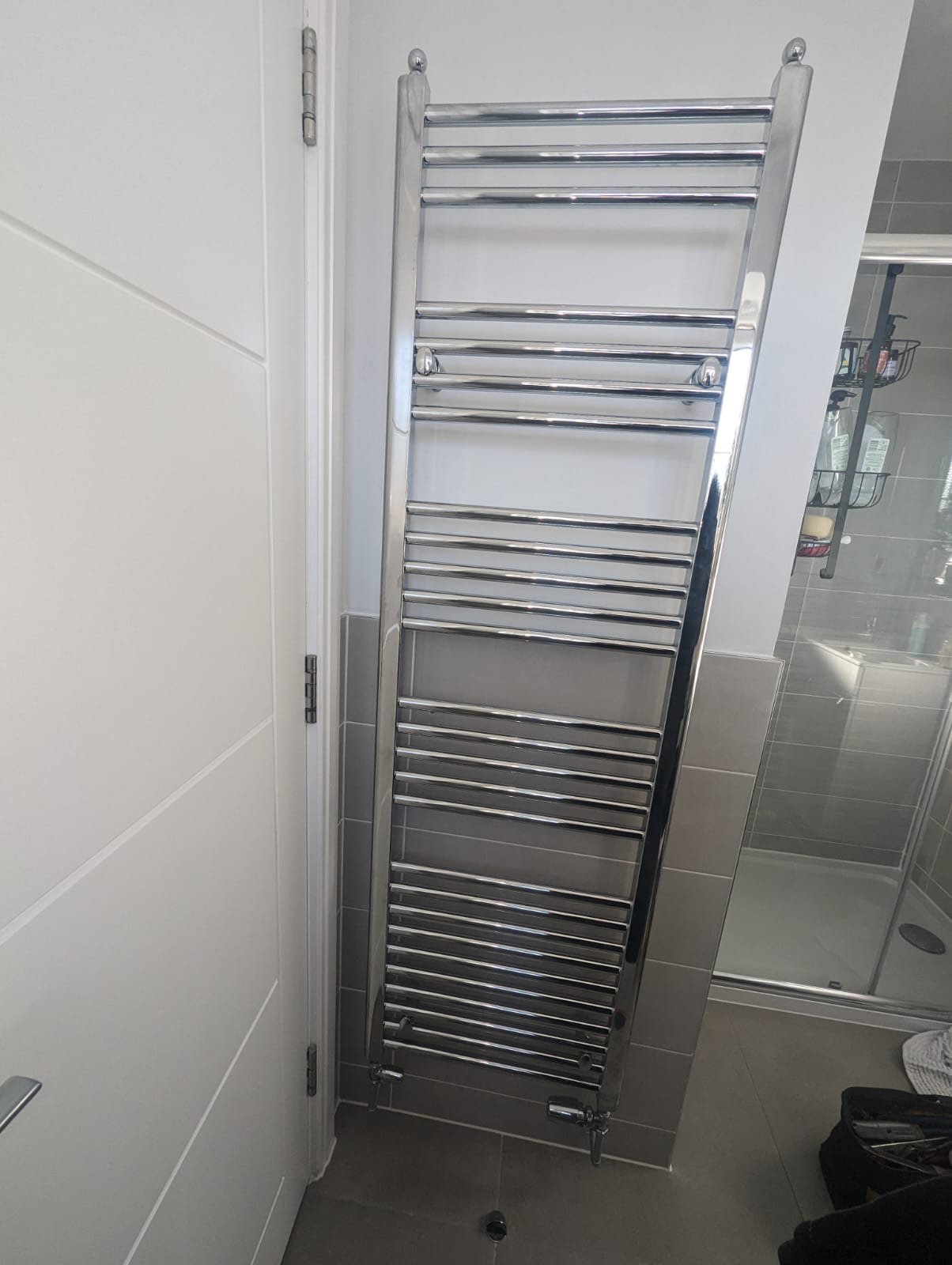 Heated towel rail fitted and connected in a finished bathroom