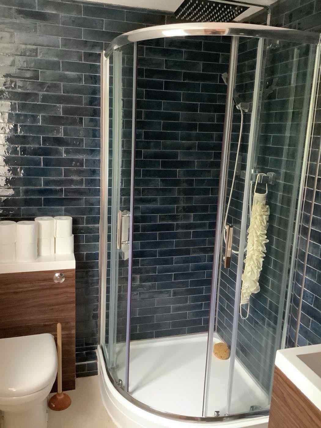 Shower enclosure with dark metro tiling